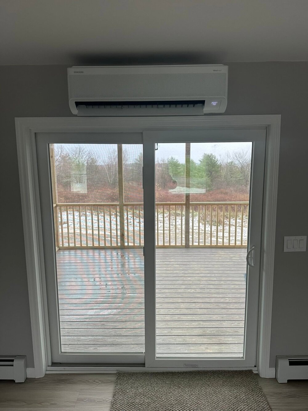 Samsung WindFree ductless head installed above a patio door — Barnett Heat Pumps