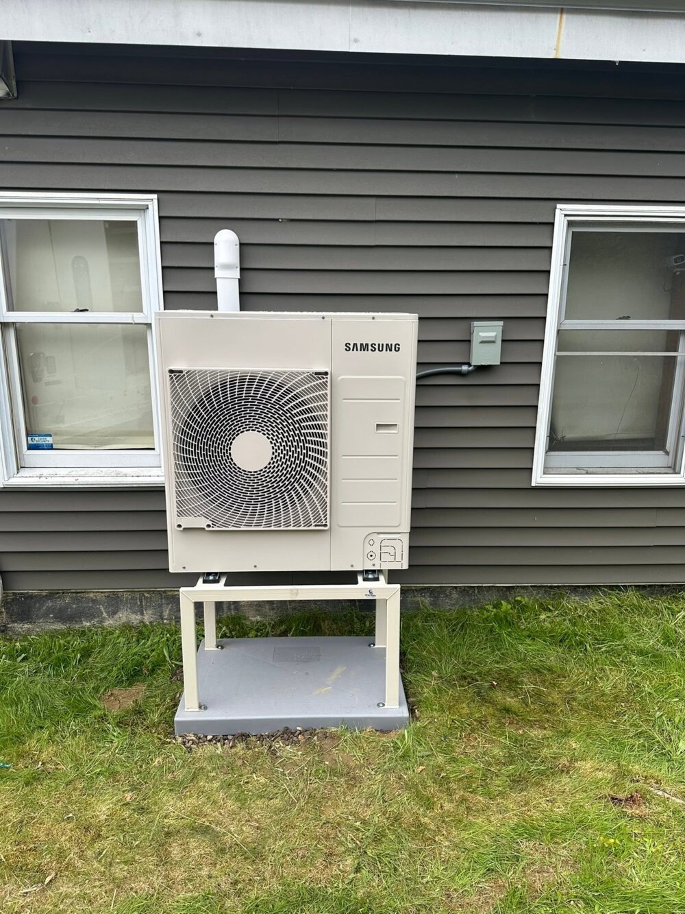 Samsung outdoor heat pump condenser on a stand — Barnett Heat Pumps, central Maine
